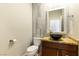 Stylish powder room with a unique vessel sink, decorative mirror, and modern tile accents at 7909 Rio Rico Dr, Las Vegas, NV 89113
