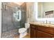 Modern bathroom with a walk-in shower, pebble floor, and granite countertop vanity at 7909 Rio Rico Dr, Las Vegas, NV 89113