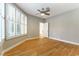Bedroom featuring light grey walls, light wood floors, a ceiling fan, and white plantation shutters at 7909 Rio Rico Dr, Las Vegas, NV 89113