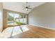 Bright bedroom with wood floors, a ceiling fan, and large sliding doors with a view of the backyard pool at 7909 Rio Rico Dr, Las Vegas, NV 89113