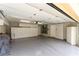 Garage with epoxy floors, storage cabinets, and overhead lighting at 7909 Rio Rico Dr, Las Vegas, NV 89113