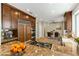 Open-concept kitchen boasts granite counters, wood cabinets, stainless appliances, and adjacent dining area at 7909 Rio Rico Dr, Las Vegas, NV 89113