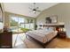 Staged main bedroom features vaulted ceilings, patio access, ceiling fan, and neutral colors at 7909 Rio Rico Dr, Las Vegas, NV 89113