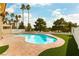 An outdoor pool with palm trees and manicured landscaping at 7909 Rio Rico Dr, Las Vegas, NV 89113