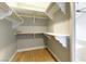 Empty walk-in closet featuring white shelving, neutral paint, and wood floors at 7909 Rio Rico Dr, Las Vegas, NV 89113