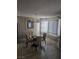 Bright dining room with a glass-top table and four chairs at 7964 Rim Rock Way # 102, Las Vegas, NV 89128