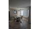Bright dining room with a glass-top table and four chairs at 7964 Rim Rock Way # 102, Las Vegas, NV 89128