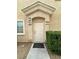 Inviting front entrance with covered porch, manicured bushes, and unit number at 8834 Duncan Barrel Ave # 103, Las Vegas, NV 89178