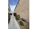Side view of townhouse exterior showcasing gravel landscaping and utility access at 8834 Duncan Barrel Ave # 103, Las Vegas, NV 89178