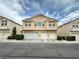 Inviting townhouse featuring a multi-car garage and charming curb appeal with manicured landscaping at 8834 Duncan Barrel Ave # 103, Las Vegas, NV 89178