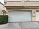 Spacious multi-car garage with white door and exterior lighting at 8834 Duncan Barrel Ave # 103, Las Vegas, NV 89178