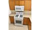 Functional kitchen featuring white appliances and wood cabinets at 8834 Duncan Barrel Ave # 103, Las Vegas, NV 89178