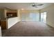 View of living room with neutral walls, carpet, and sliding glass door at 8834 Duncan Barrel Ave # 103, Las Vegas, NV 89178