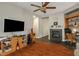 Living room with hardwood floors, a fireplace, and built-in entertainment center at 9644 Padre Peak Ct, Las Vegas, NV 89178