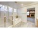 Bathroom with soaking tub, shower, and views to living room at 10016 Diving Duck Ave, Las Vegas, NV 89117