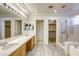 Elegant bathroom with double vanity, shower, and tub at 10016 Diving Duck Ave, Las Vegas, NV 89117