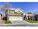 Two-story house with a two-car garage and landscaped lawn at 10016 Diving Duck Ave, Las Vegas, NV 89117