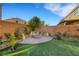 Backyard with fire pit and artificial turf at 10166 Bishops Peak Ct, Las Vegas, NV 89141