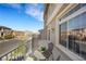 Private balcony overlooking the street with a small table and chairs at 10166 Bishops Peak Ct, Las Vegas, NV 89141