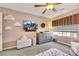 Spacious bedroom with large TV, ceiling fan, and gray dresser at 10166 Bishops Peak Ct, Las Vegas, NV 89141