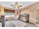 Charming bedroom with crib, ceiling fan, and whimsical wall art at 10166 Bishops Peak Ct, Las Vegas, NV 89141