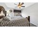 Well-lit bedroom with ceiling fan and a queen bed at 10166 Bishops Peak Ct, Las Vegas, NV 89141