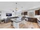 Open concept kitchen with granite island, stainless steel appliances, and living area view at 10166 Bishops Peak Ct, Las Vegas, NV 89141