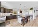 Modern kitchen with dark cabinetry, granite island, and stainless steel appliances at 10166 Bishops Peak Ct, Las Vegas, NV 89141