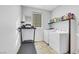 Laundry room with washer, dryer, treadmill, and storage shelving at 10166 Bishops Peak Ct, Las Vegas, NV 89141