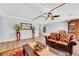 Living room with hardwood floors, leather furniture, and access to stairs at 10166 Bishops Peak Ct, Las Vegas, NV 89141