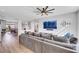 Living room with large sectional sofa, hardwood floors, and a TV at 10166 Bishops Peak Ct, Las Vegas, NV 89141