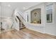 Modern staircase with glass and metal railing, leading to the upper level at 10166 Bishops Peak Ct, Las Vegas, NV 89141