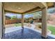 Covered patio overlooking a landscaped backyard with putting green at 10489 Bolting Cloud Dr, Las Vegas, NV 89178