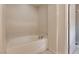 Oval bathtub with neutral tile and shower at 10489 Bolting Cloud Dr, Las Vegas, NV 89178