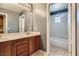 Bathroom with double vanity, large mirror, and separate tub at 10489 Bolting Cloud Dr, Las Vegas, NV 89178