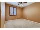 Spacious bedroom with carpeted floor and ceiling fan at 10489 Bolting Cloud Dr, Las Vegas, NV 89178