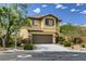 Two-story house with brown garage door and landscaping at 10489 Bolting Cloud Dr, Las Vegas, NV 89178