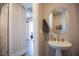 Small powder room with pedestal sink and mirror at 11280 Granite Ridge Dr # 1032, Las Vegas, NV 89135