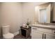 Modern powder room with white vanity, grey countertop, and designer fixtures at 11280 Granite Ridge Dr # 1032, Las Vegas, NV 89135