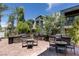 Outdoor grilling area with multiple BBQ stations, seating, and paved patio at 11327 Gravitation Dr, Las Vegas, NV 89135