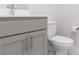 Gray vanity with white countertop, toilet and tile floor at 11327 Gravitation Dr, Las Vegas, NV 89135