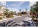 Gated community entrance with palm trees and brick driveway at 11327 Gravitation Dr, Las Vegas, NV 89135