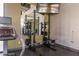 Modern gym with weightlifting equipment and a mirror at 11327 Gravitation Dr, Las Vegas, NV 89135