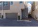 Modern gray garage with paved driveway and landscaping at 11327 Gravitation Dr, Las Vegas, NV 89135