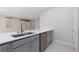 Modern kitchen with gray cabinets and a large island at 11327 Gravitation Dr, Las Vegas, NV 89135