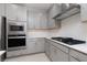 Modern kitchen with gray cabinets and gas cooktop at 11327 Gravitation Dr, Las Vegas, NV 89135