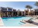 Resort-style pool with plenty of lounge chairs and surrounding landscaping at 11327 Gravitation Dr, Las Vegas, NV 89135