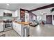 Open concept kitchen flows into living area, featuring butcher block island at 1205 Sattes St, Las Vegas, NV 89101