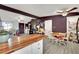 Kitchen with butcher block island opens to dining area with wood chairs at 1205 Sattes St, Las Vegas, NV 89101