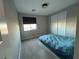 Cozy bedroom with plush carpet, window, and double doors at 12422 Tudor Arch Dr, Las Vegas, NV 89138